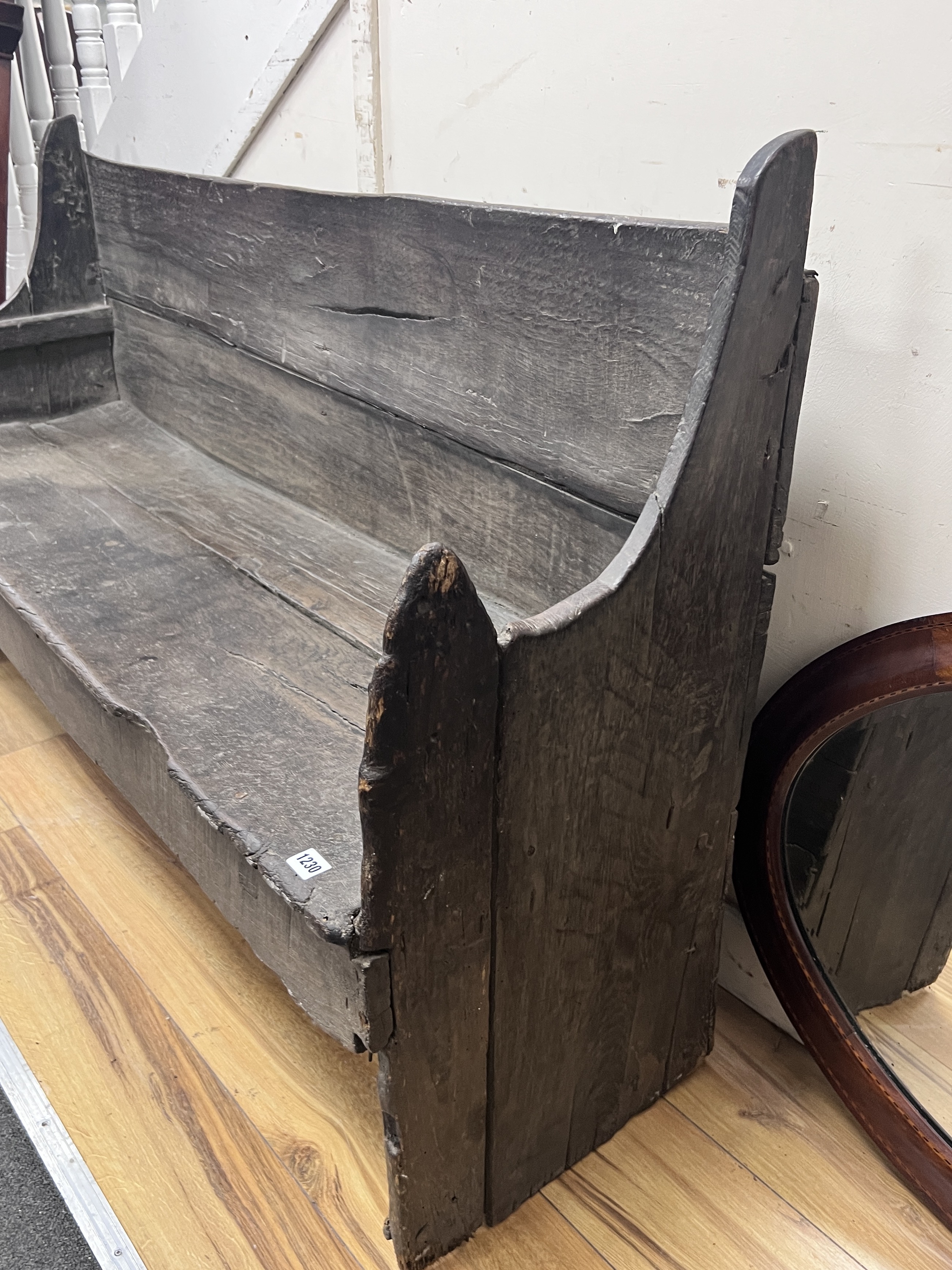 An 18th century rustic oak bench, length 142cm, depth 40cm, height 84cm